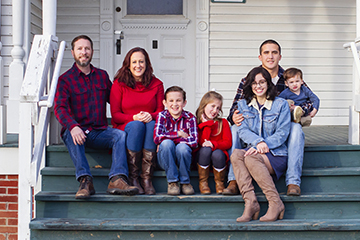 family sitting on steps at harlinsdale farm in franklin tn